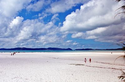 Scenic view of beach against cloudy sky