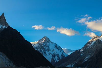 Scenic view of snowcapped mountains against blue sky