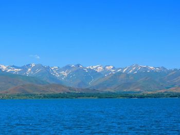 Scenic view of mountains against clear blue sky