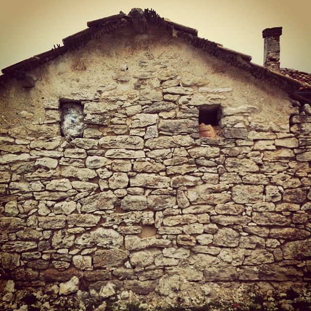 architecture, built structure, building exterior, brick wall, stone wall, low angle view, wall - building feature, old, house, brick, textured, outdoors, weathered, day, abandoned, no people, damaged, stone material, wall, stone