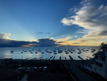 High angle view of buildings by sea against sky