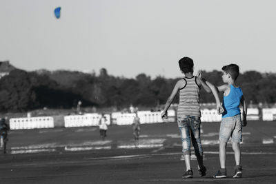 Boy standing against sky
