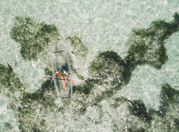 Aerial view of woman kayaking in sea