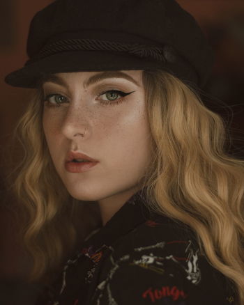 Close-up portrait of beautiful young model wearing cap