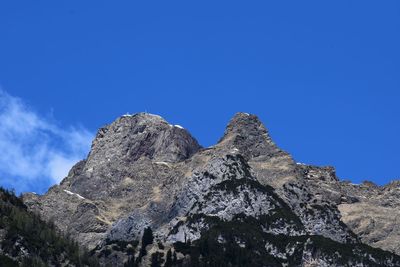 Low angle view of rock formation against blue sky