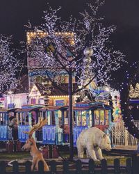 View of illuminated statue on christmas tree at night