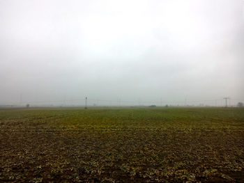 Scenic view of field against sky during foggy weather
