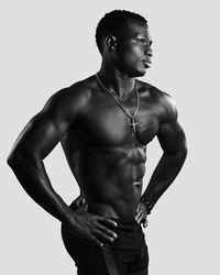 Young man looking away against white background