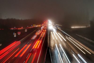 High angle view of light trails on highway at night