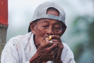 Close-up of man igniting cigarette