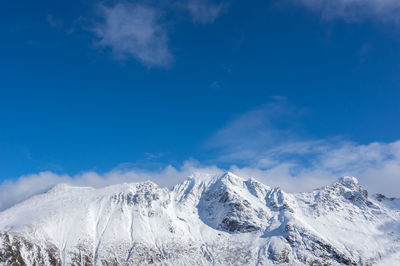 Scenic view of snowcapped mountains against blue sky norway