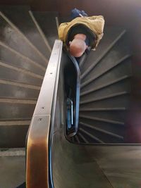 Close-up of boy standing on staircase