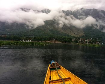 Scenic view of lake by mountains against sky