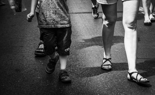 Low section of people standing on street