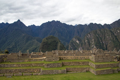 Scenic view of mountains against cloudy sky