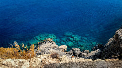 High angle view of rocks by sea