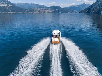 High angle view of nautical vessel on sea against mountain