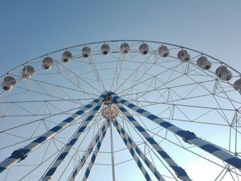 Low angle view of ferris wheel against clear sky