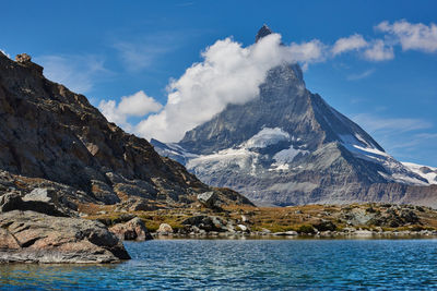 Scenic view of snowcapped mountains against sky