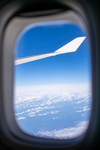 Scenic view of blue sky seen through airplane window