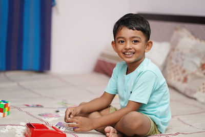 Portrait of cute girl sitting at home