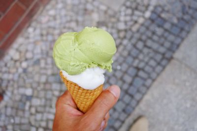 Close-up of hand holding ice cream cone