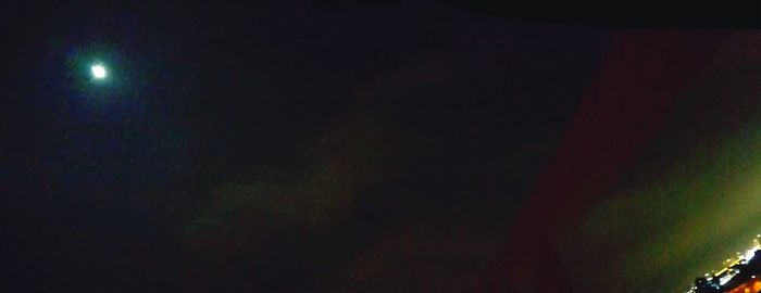 Close-up of illuminated lights against sky
