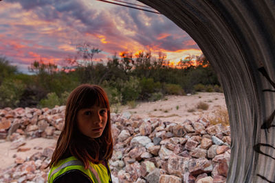 Portrait of girl in tunnel during sunset