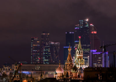 Illuminated cityscape against sky at night