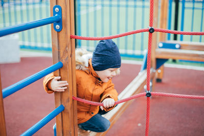 Low angle view of girl playing in playground
