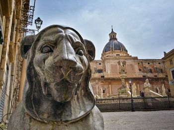 Animal statue against built structure