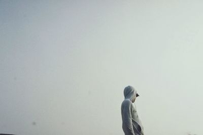Rear view of woman standing against clear sky