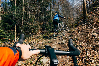 Man riding bicycle in forest