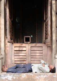 Man sleeping outside house