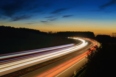 High angle view of light trails on highway at night