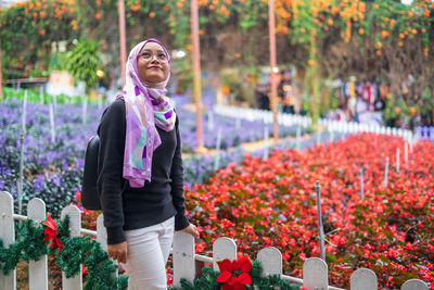 Woman standing on flowering plants