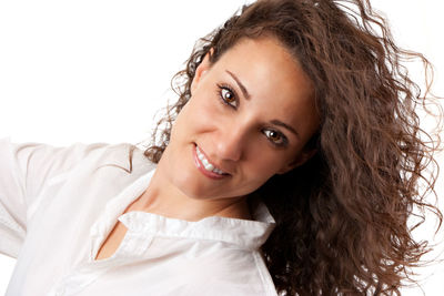 Portrait of a smiling young woman over white background