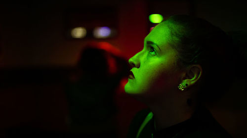 Portrait of young woman looking away in a nightclub 