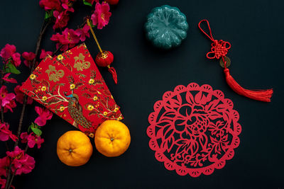 Chinese lunar new year decoration over black background. flat lay concept festive decoration. 