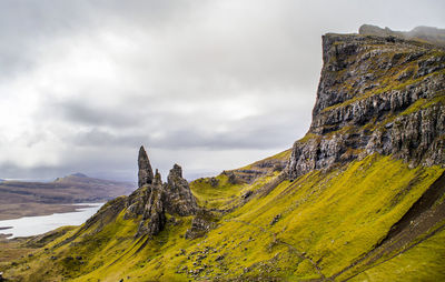 Scenic view of mossy mountain against sky