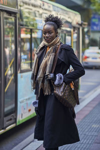 Portrait of woman standing in city