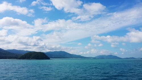 Scenic view of mountain range against cloudy sky