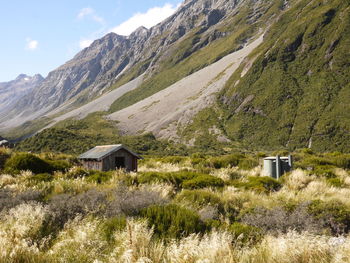 Houses on mountain against sky