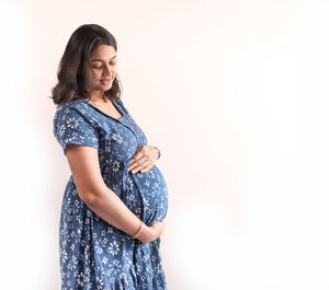 Young woman standing against white background