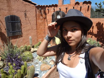 Portrait of young woman wearing hat