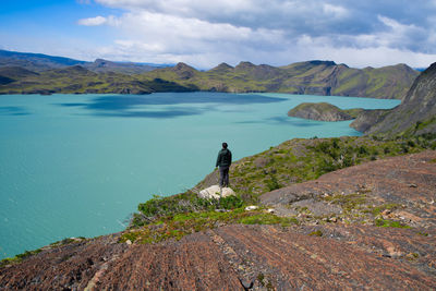 Man looking at view of mountain against sky