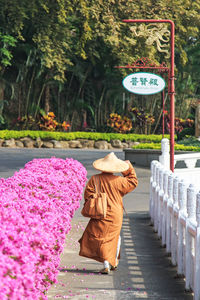 Rear view of monk walking on walkway at fo guang shan