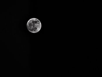 Low angle view of moon against sky at night