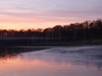 Scenic view of lake against romantic sky at sunset