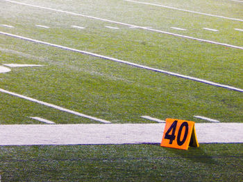 High angle view of arrow sign on field